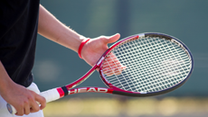 tennis racket in hand
