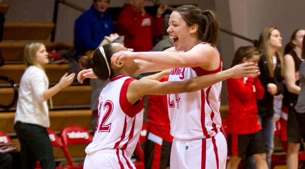 Sophomore Enri Small (left) celebrates with senior Kim Replogle (right) following a thrilling comeback and 55-54 win over Ohio Wesleyan on Saturday. Photo by Erin Pence