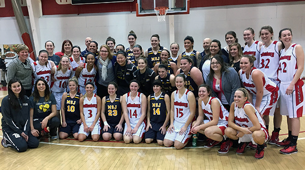 Wittenberg and Mount St. Joseph players rally around Lauren Hill after the game. Photo by John Strawn
