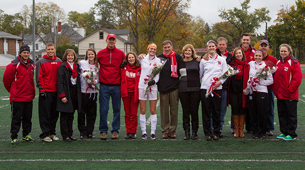 Seniors Mary Clare Yerke, Tobie Weston, Erika Rich and Chelsey Marcum celebrate Senior Recognition Day with their parents and coaches on the field before a 4-1 win over Hiram. Photo by Erin Pence